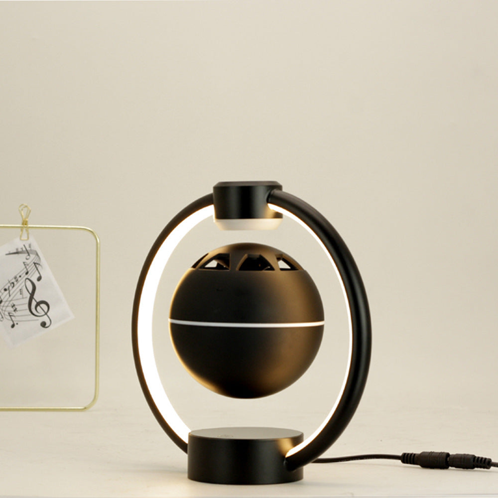 Black magnetic levitation Bluetooth speaker with circular LED light ring for wireless home audio and decoration