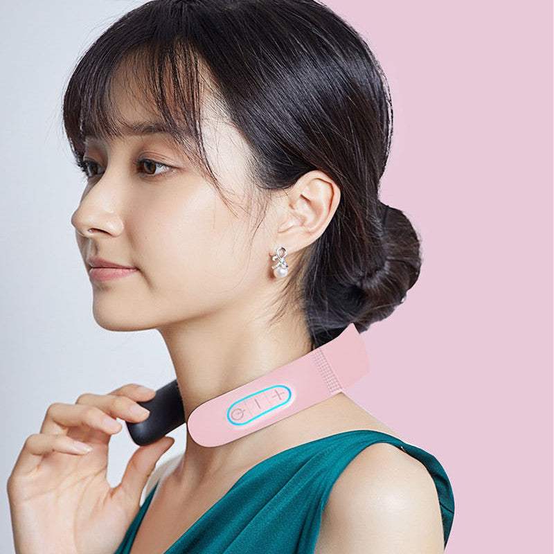 Woman using pink electric pulse cervical massager for neck and shoulder pain relief