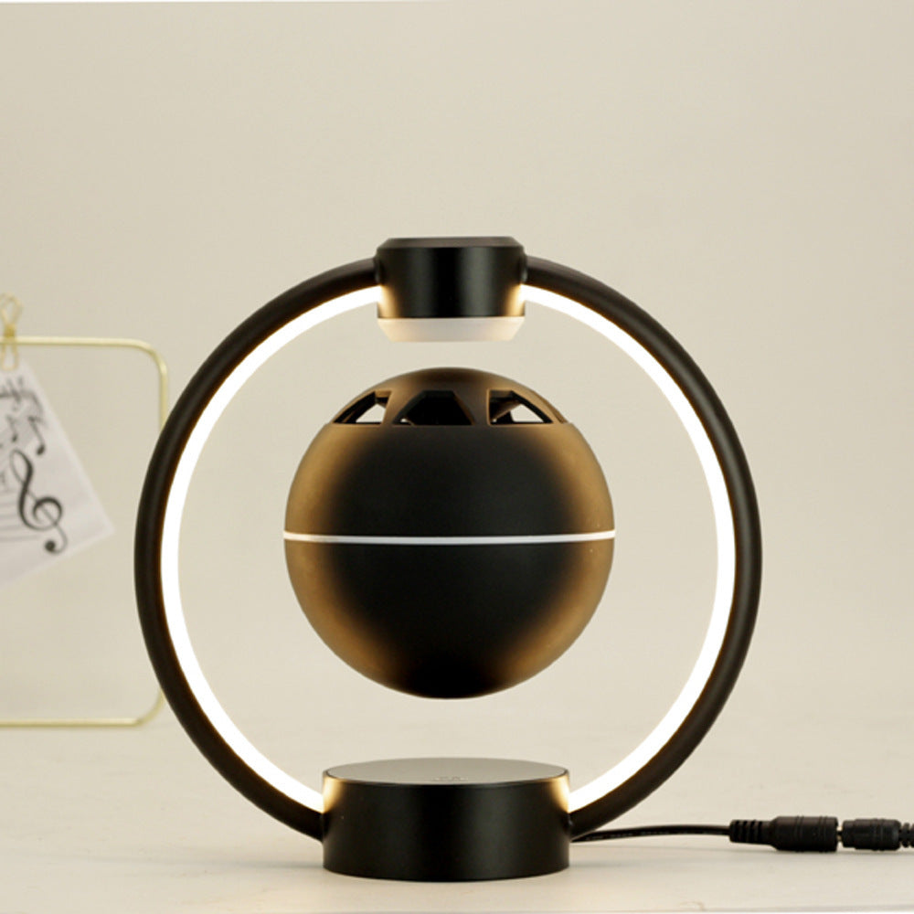 Magnetic levitation Bluetooth speaker with circular LED light and black spherical design for wireless audio and home decor